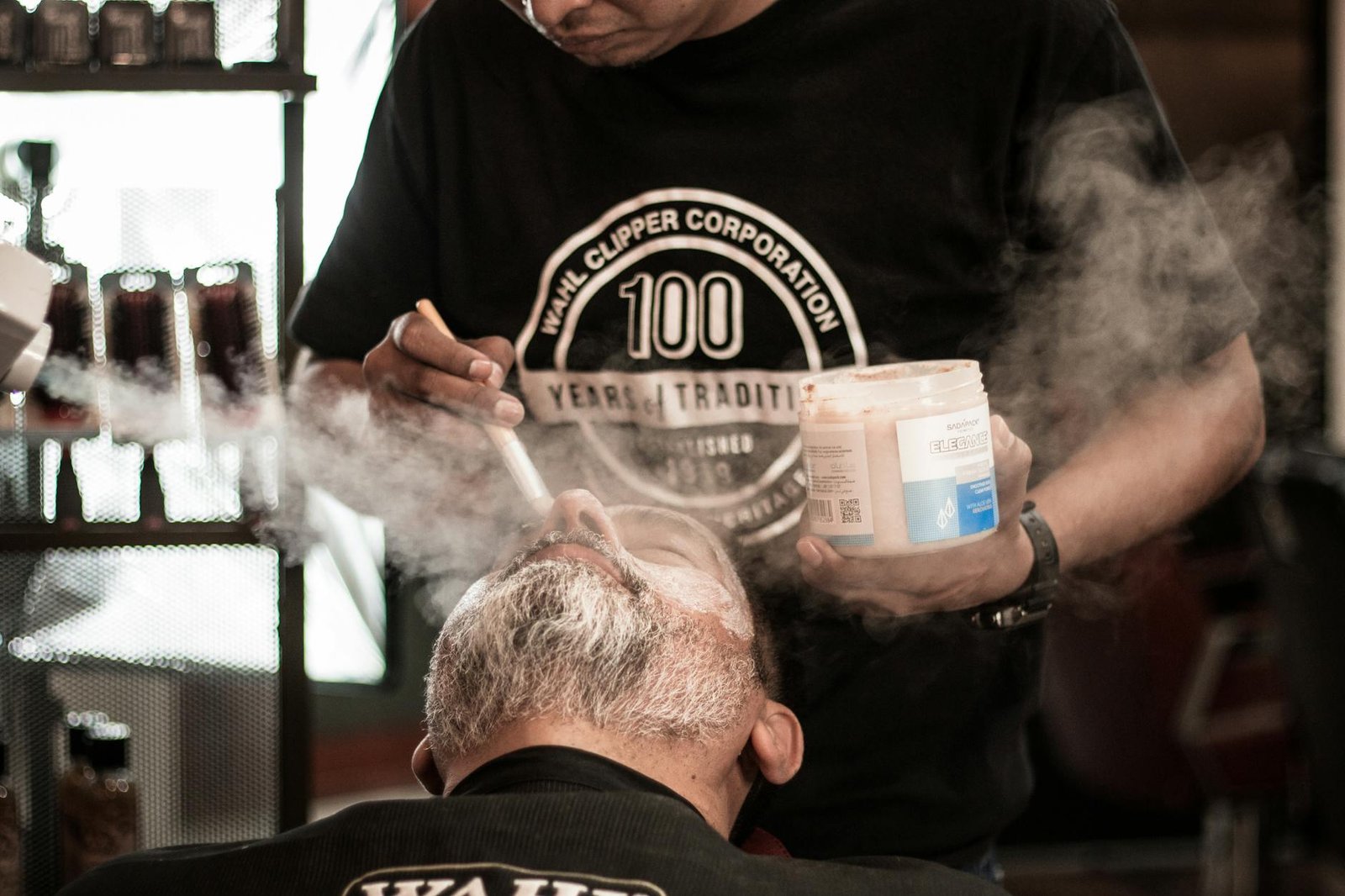 https://www.pexels.com/photo/a-barber-brushing-powder-on-a-mans-beard-18704464/